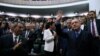 Turkish President Recep Tayyip Erdogan greets members of parliament from his ruling AK Party during a meeting in Ankara, April 24, 2018. 