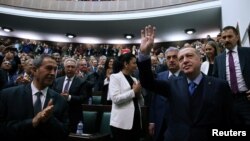 Turkish President Recep Tayyip Erdogan greets members of parliament from his ruling AK Party during a meeting in Ankara, April 24, 2018. 